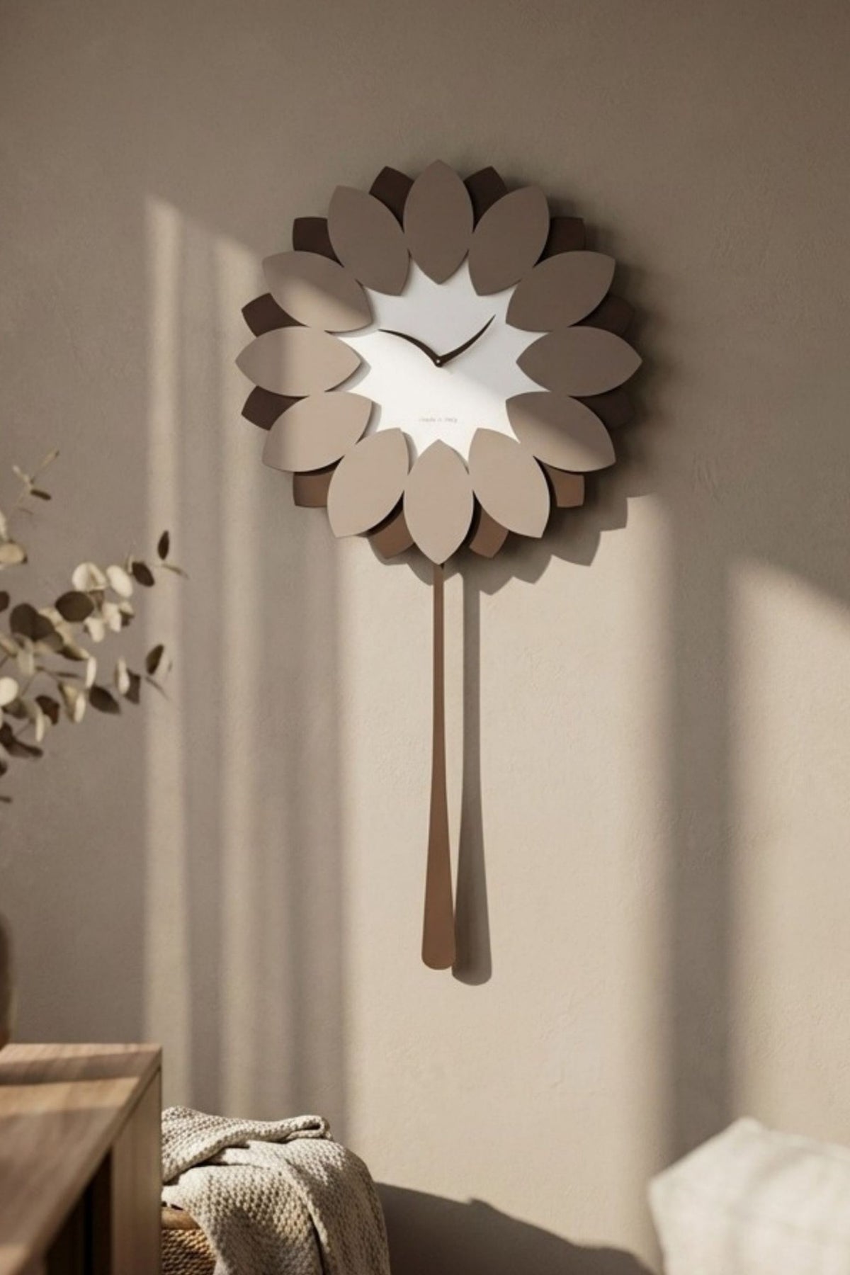 CalleaDesign Flip pendulum clock in Café Latte finish in a warm contemporary interior