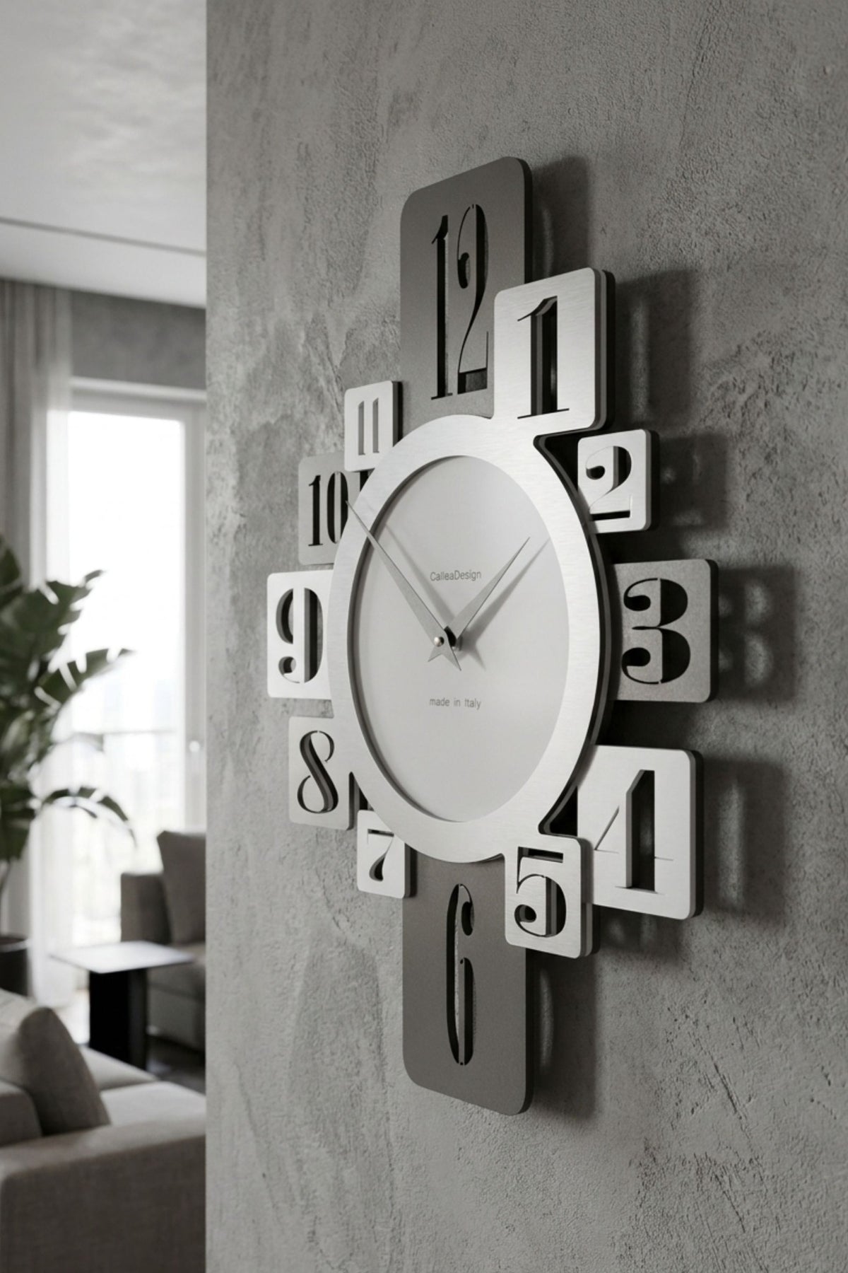 CalleaDesign Onyx wall clock in white and grey finishes shown from an angled close-up on a textured wall in a contemporary interior