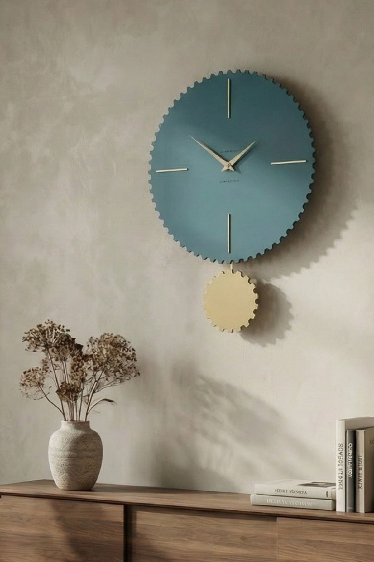 CalleaDesign Riz pendulum clock in blue and gold finish in a warm contemporary interior