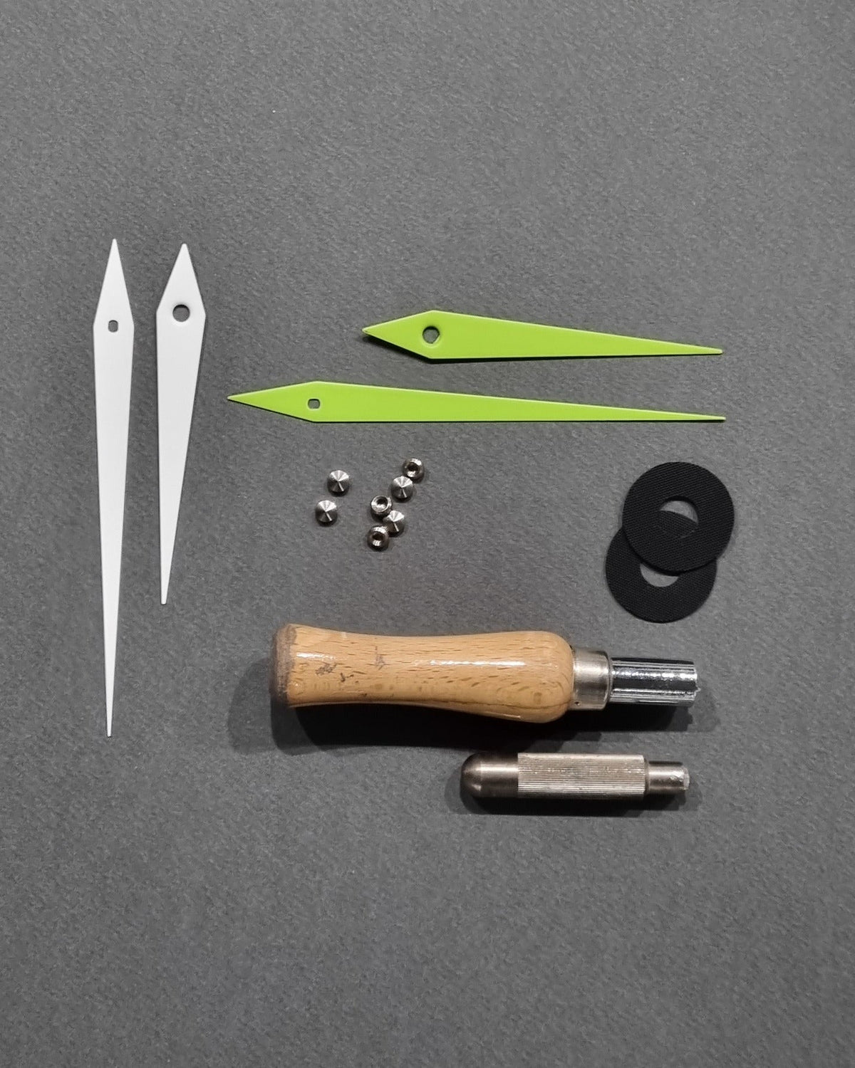 Clock hands and small components prepared for assembly in the CalleaDesign atelier