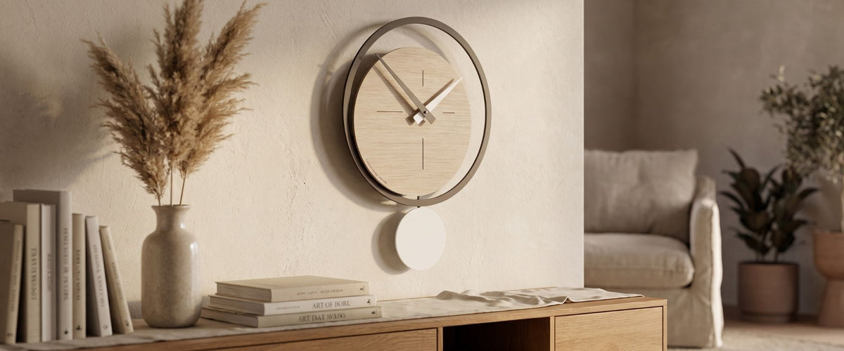 CalleaDesign pendulum wall clock in a light wood finish styled in a warm contemporary interior