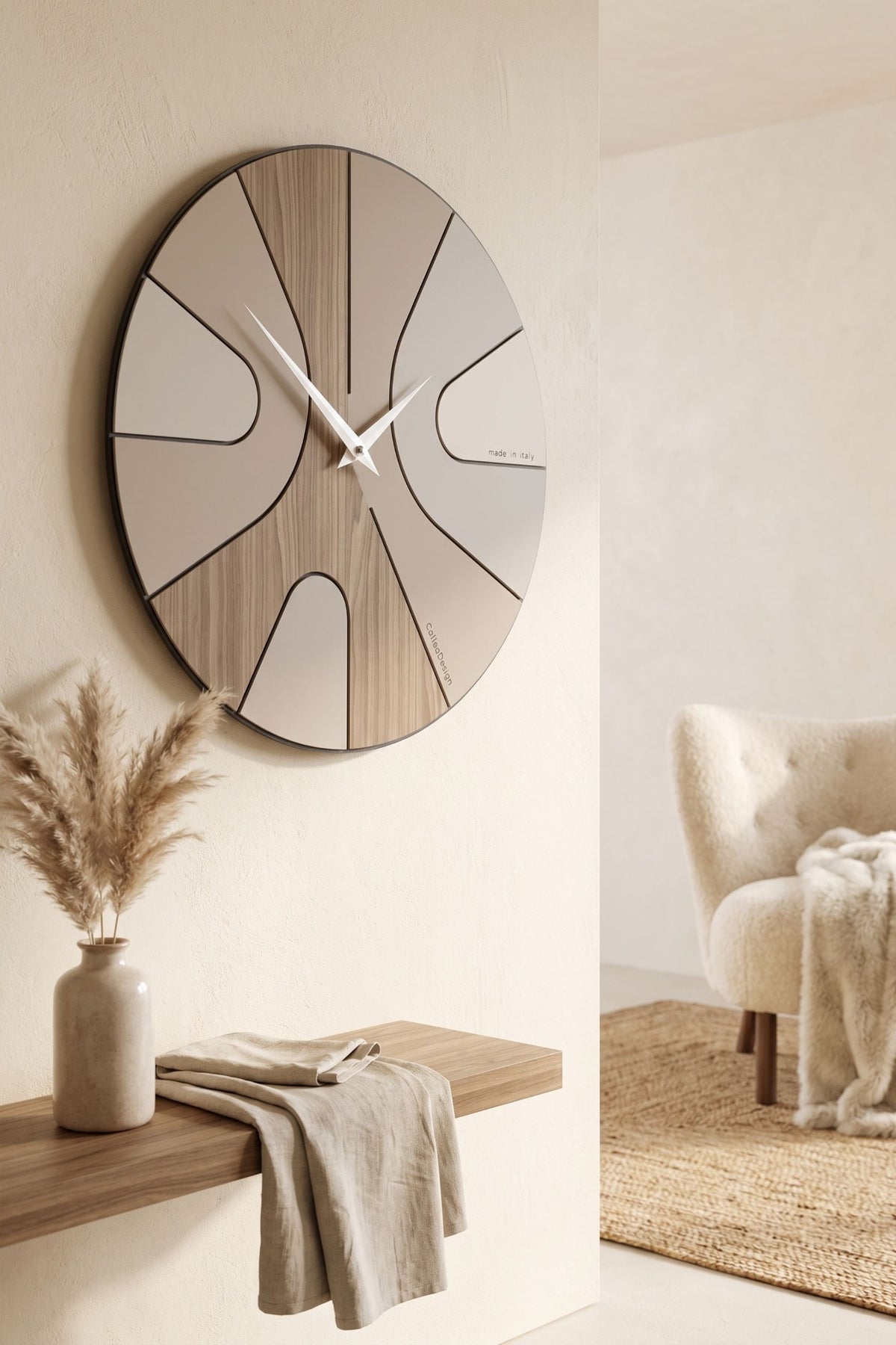 CalleaDesign Asym wall clock in Black Walnut and greige finish above a wooden shelf in a warm contemporary interior