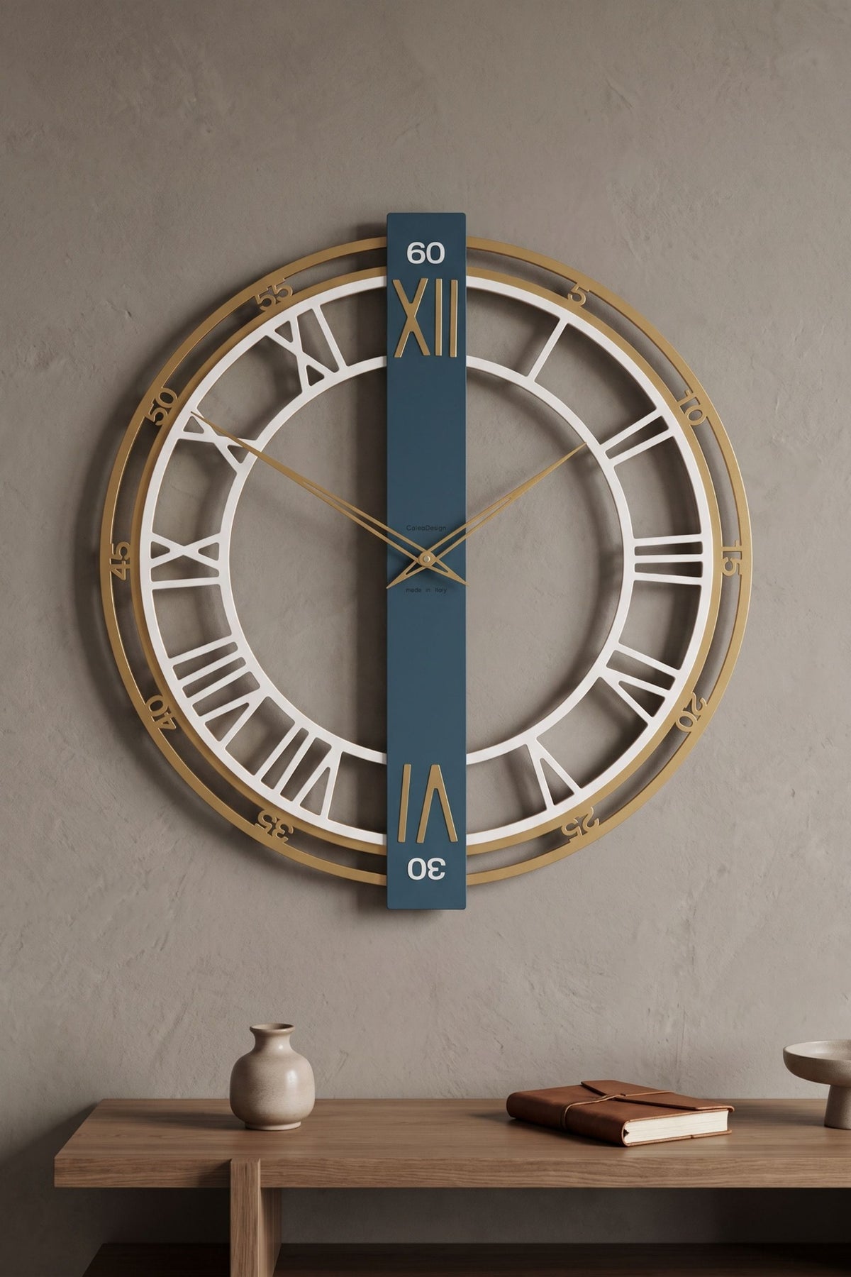 CalleaDesign Franz wall clock in Dark Teal, gold and white finish above a wooden console in a contemporary interior