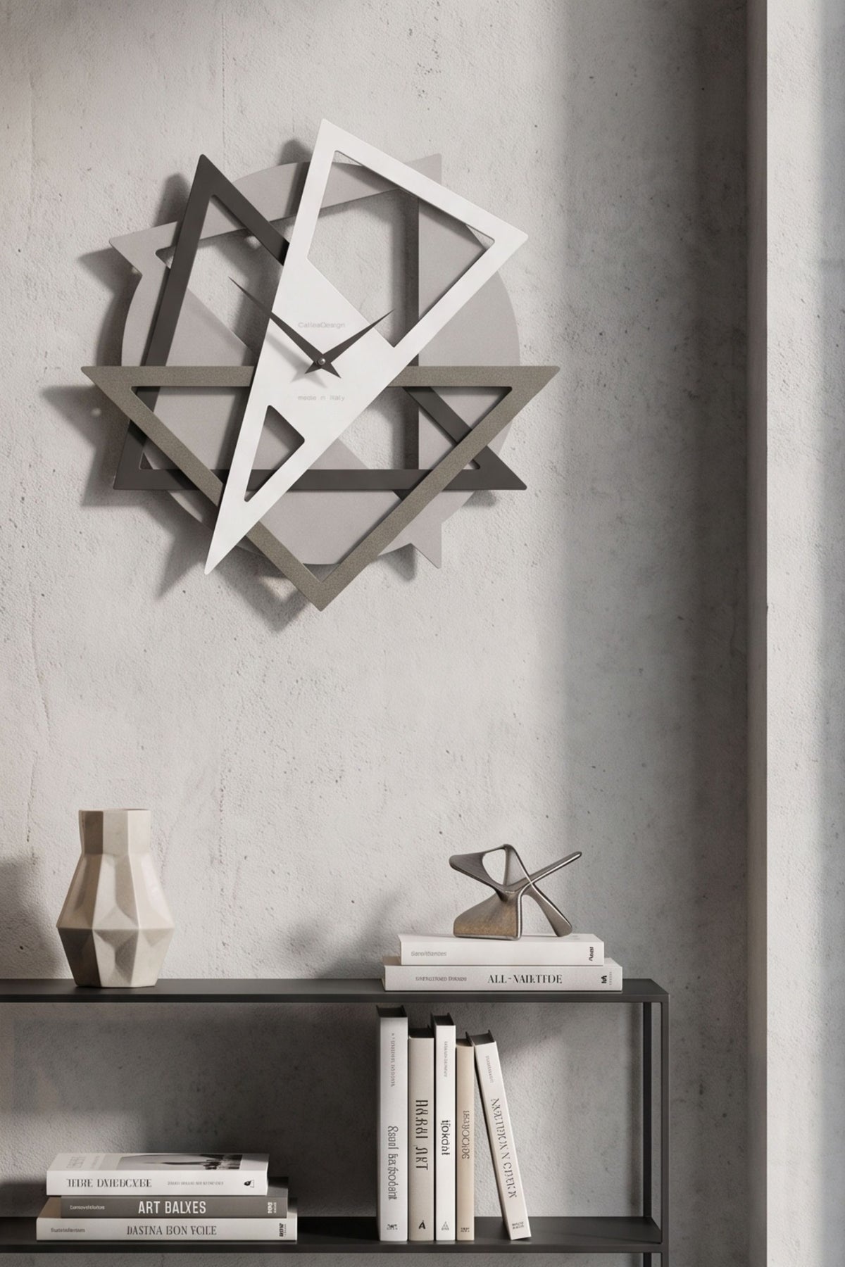 CalleaDesign Geolo wall clock in white and greige finishes above a black console in a contemporary interior