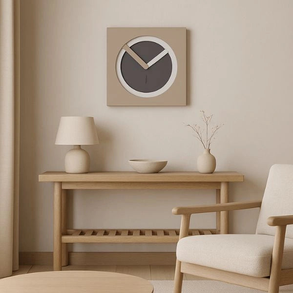 KAM Cenere wall clock above a pale wooden console in a calm neutral living room