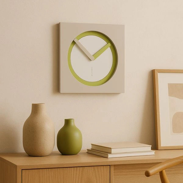 KAM Linfa wall clock above a wooden sideboard in a warm interior with ceramic vases