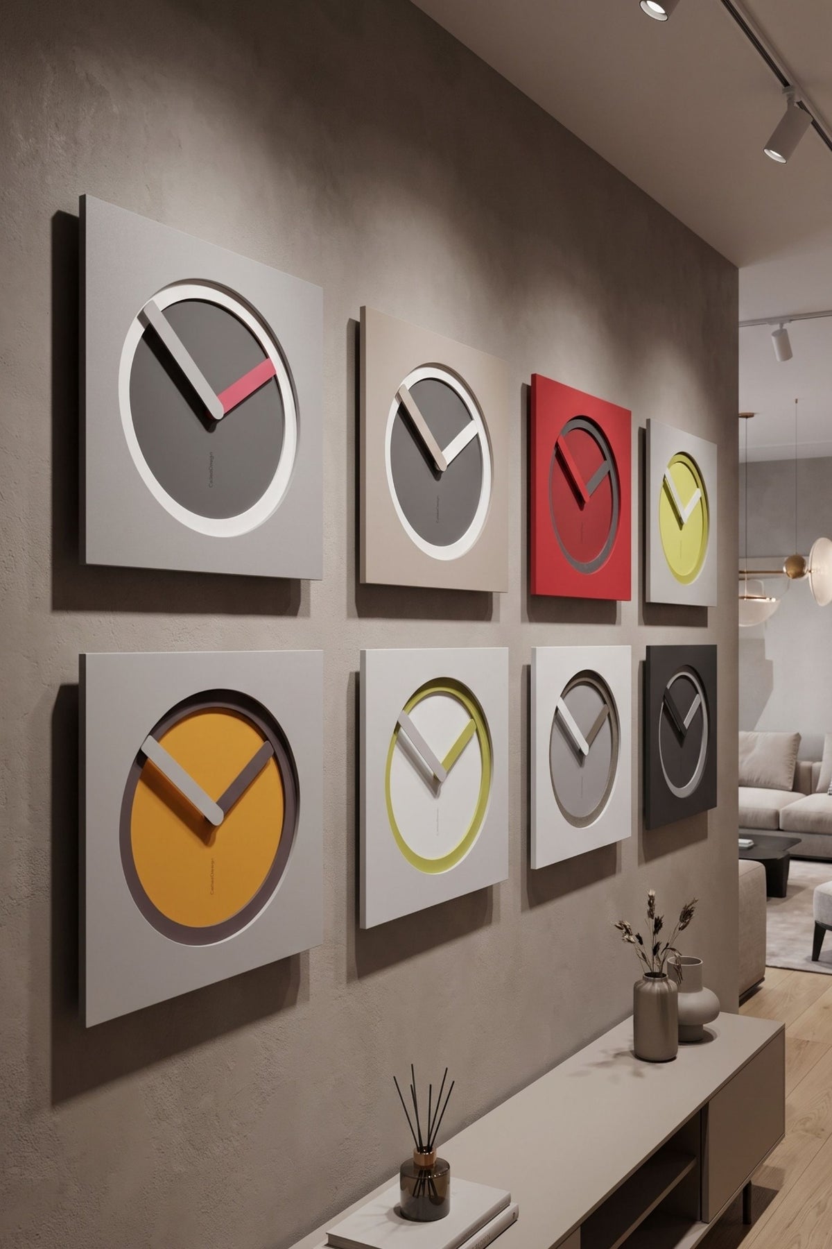 KAM Origine wall clocks in multiple colour compositions displayed in a contemporary interior