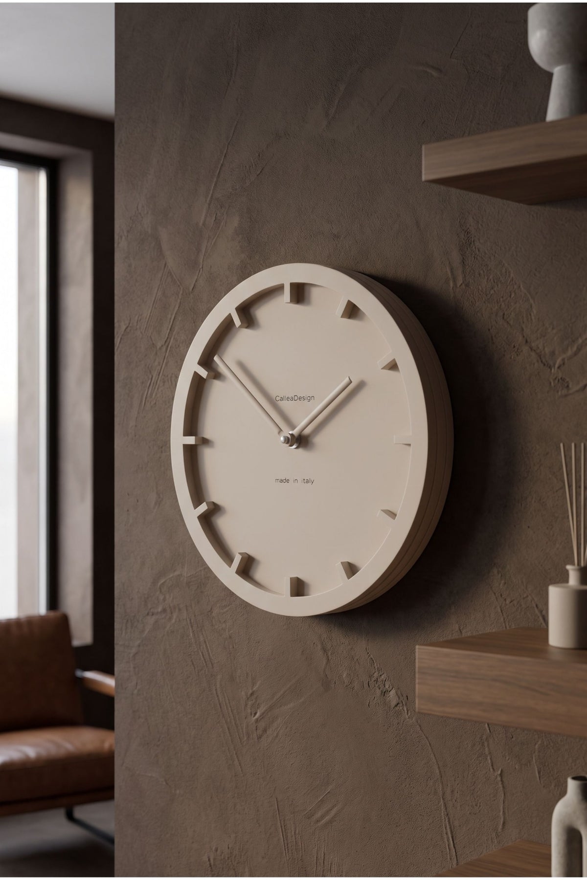 CalleaDesign Mini wall clock in a warm neutral finish on a textured wall