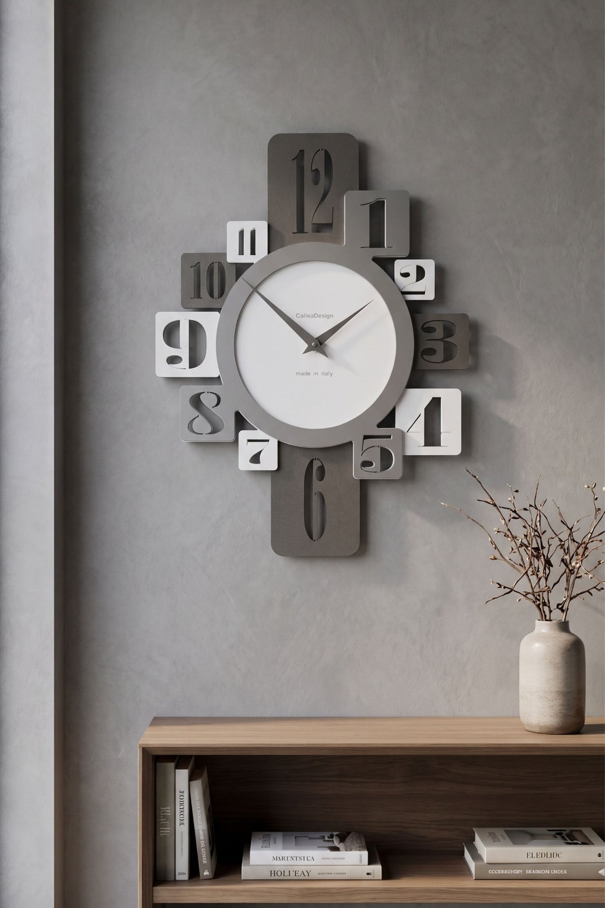 CalleaDesign Onyx wall clock in white and grey finishes above a wooden console in a contemporary interior