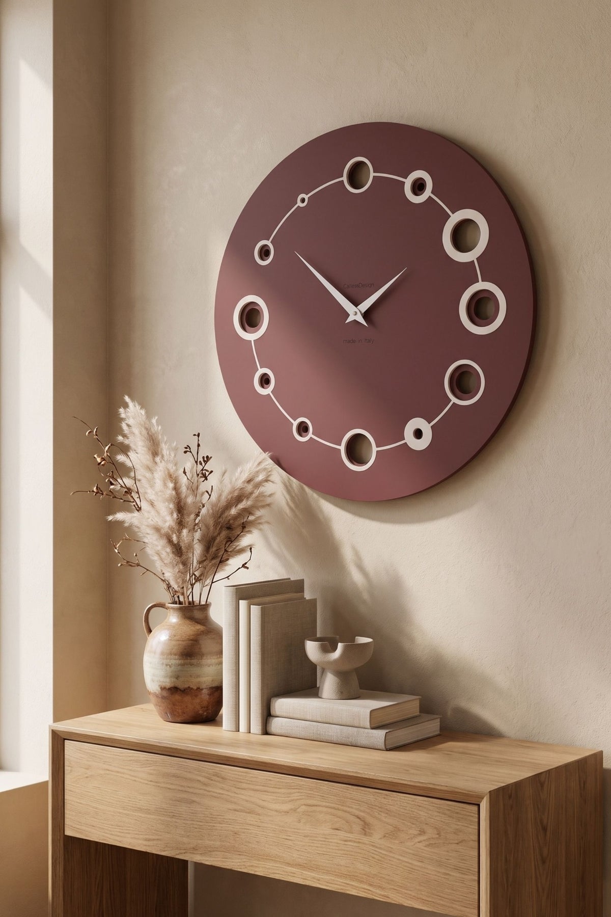CalleaDesign Orbit wall clock in Red Wine finish in a warm contemporary interior