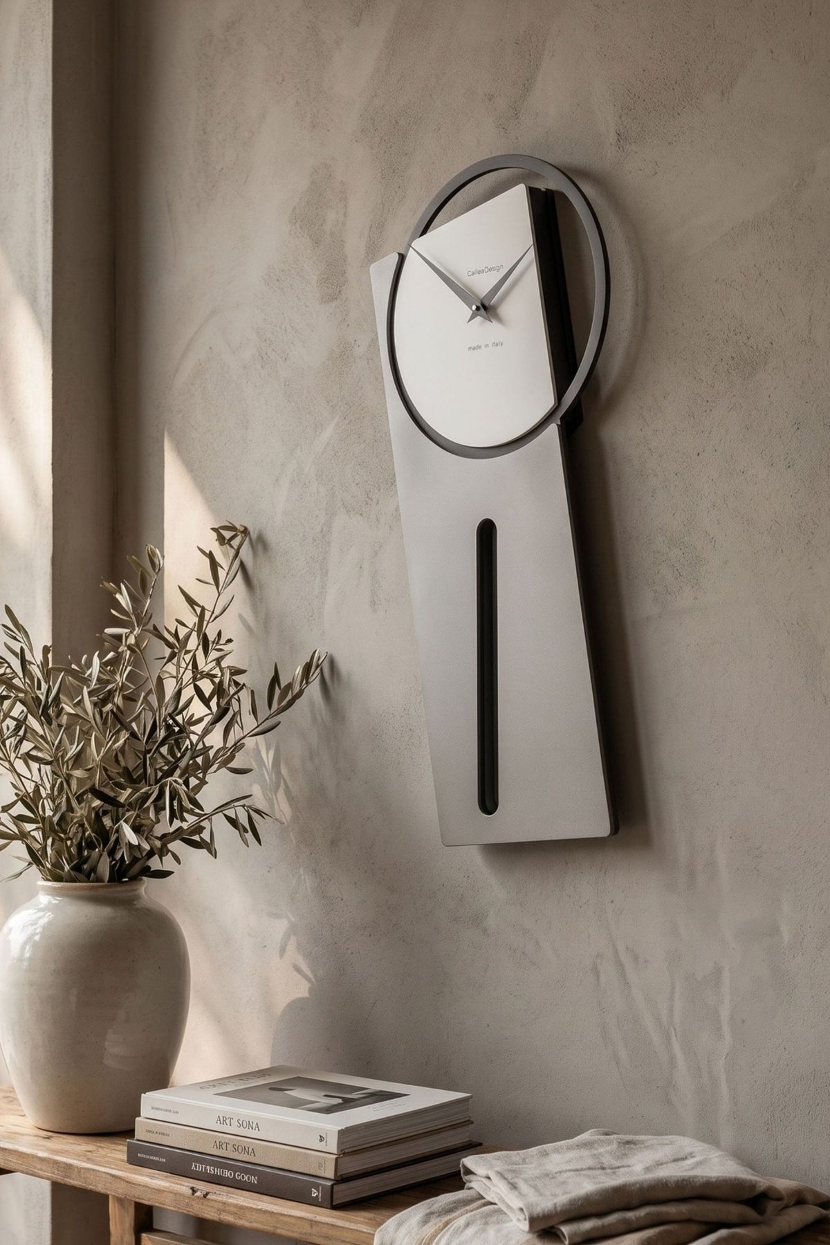 CalleaDesign Sherlock pendulum clock in Sottsass Grey finish in a modern interior